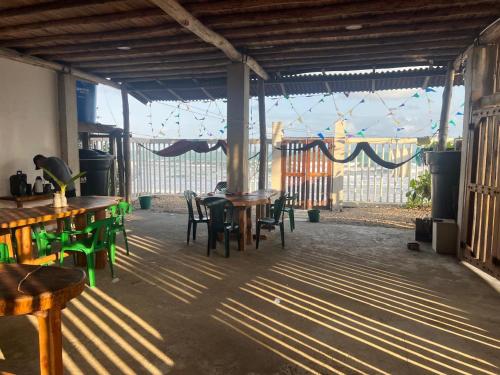a patio with tables and chairs in a building at Cabaña los recuerdos de ella in Moñitos