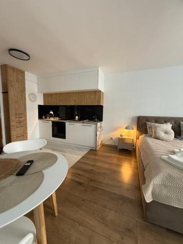 a living room with a bed and a table at DeLuxury Apartment Chmielna in Warsaw