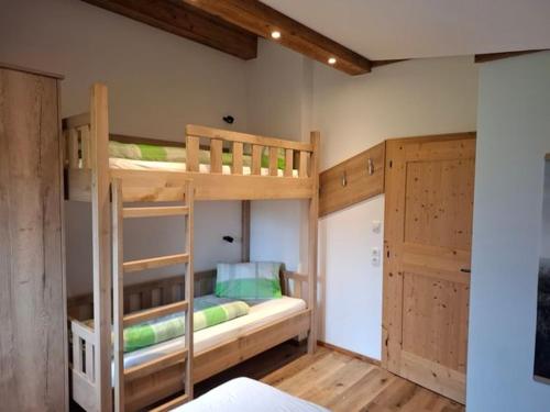 a bedroom with two bunk beds in a room at Mitterschützinghof in Saalfelden am Steinernen Meer