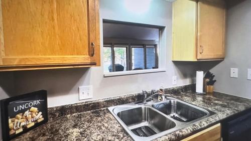 a kitchen with a sink and a counter top at No Putts Given. Cozy home on Par 4, free Golf Cart and Pool access in Osage Beach