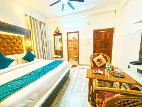 a bedroom with a bed and a table and a chair at Hotel The Premium Villa Rishikesh in Rishīkesh