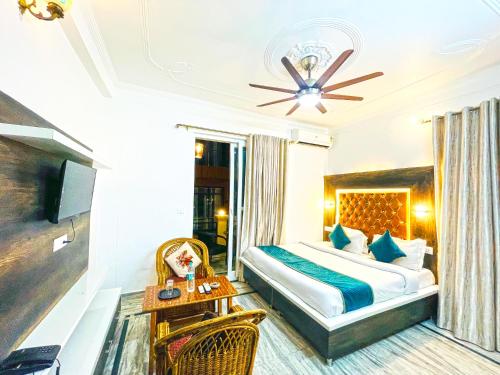 a hotel room with a bed and a table at Hotel The Premium Villa Rishikesh in Rishīkesh