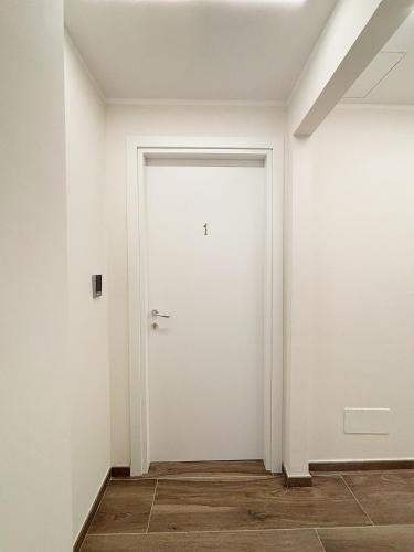 an empty room with a white door at San Siro House in Milan