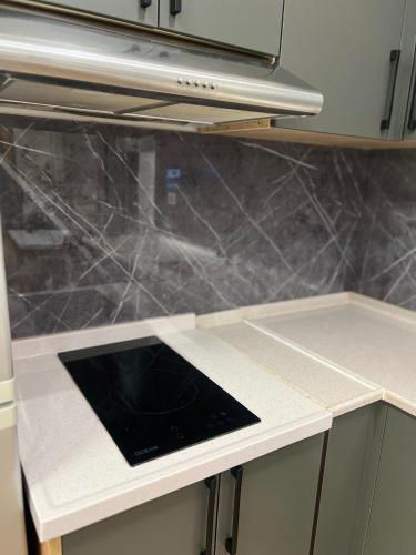 a kitchen counter with a tablet on top of it at Kamberi Hotel & Apartments in Velipojë