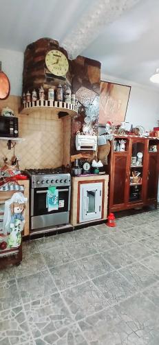a kitchen with a stove and a clock on the wall at Appartement f3 in Mostaganem