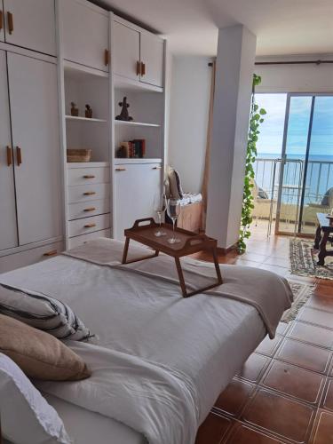 a bedroom with a bed with a table on it at Atlantic Retreat in San Marcos