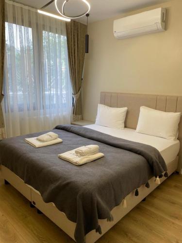 a bedroom with a bed with two towels on it at Lazmaris Suit in Çamlıhemşin