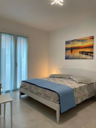a bedroom with a bed and a painting on the wall at Marina Garden in Cattolica