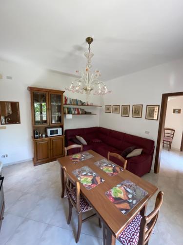 a living room with a table and a couch at Country House la Quercia in Mogliano Veneto