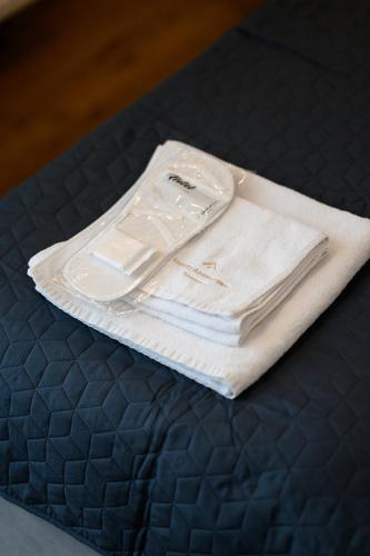 a pile of towels sitting on top of a bed at Luxury Apartments Babyak in Uzhhorod
