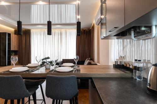 a kitchen with a large wooden table and chairs at Luxury Apartments Babyak in Uzhhorod