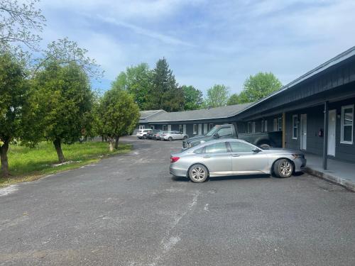 a car parked in a parking lot next to a building at Nest Inn in Watertown