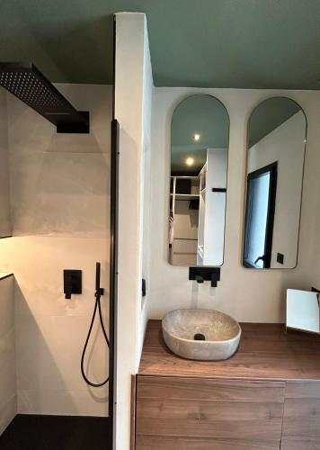 une salle de bain avec un lavabo et un miroir dans l'établissement La casa Gina, à Gouesnach