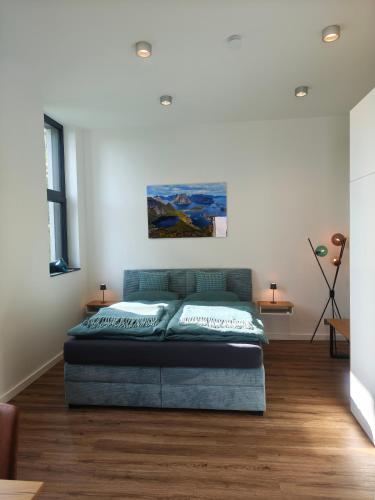 a bedroom with a bed in the middle of a room at Nordloft Bad Nenndorf in Bad Nenndorf