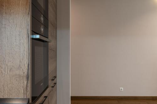 a kitchen with a stove top oven next to a wall at Luxury Apartments Babyak in Uzhhorod