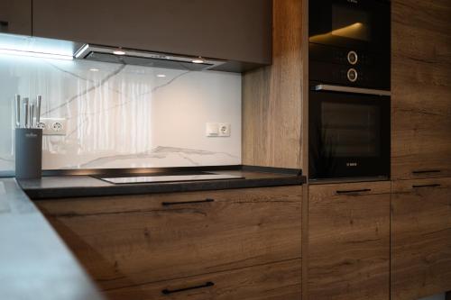 a kitchen with a stove and a microwave at Luxury Apartments Babyak in Uzhhorod