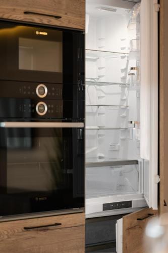 a refrigerator with its door open with its empty refrigerator at Luxury Apartments Babyak in Uzhhorod