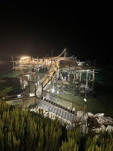 a dock at night with lights in the water at Il Tramonto in Altino