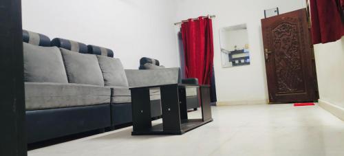a living room with a couch and a table at Hillview Homestay in Tiruvannāmalai