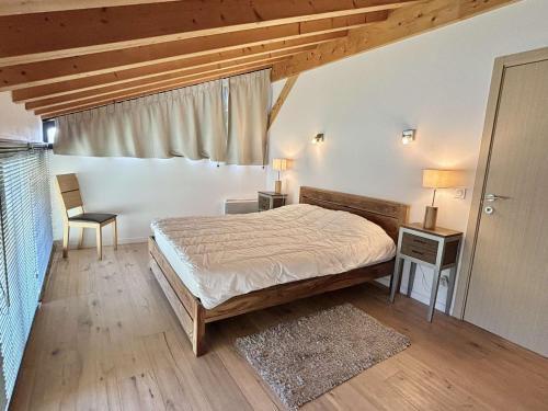a bedroom with a bed and two tables and a window at Chalet 8 pièces avec spa, sauna, 15 pers, à 800m des pistes, Notre-Dame-de-Bellecombe - FR-1-595-1 in Notre-Dame-de-Bellecombe