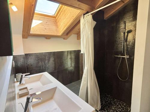 a bathroom with a shower and a white sink at Chalet 8 pièces avec spa, sauna, 15 pers, à 800m des pistes, Notre-Dame-de-Bellecombe - FR-1-595-1 in Notre-Dame-de-Bellecombe
