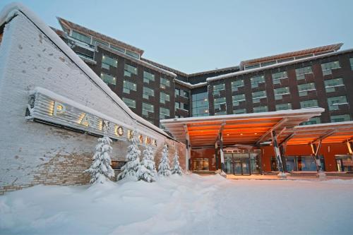 a large building with a snow covered roof at Hotel Levi Panorama & Levi Chalets in Levi