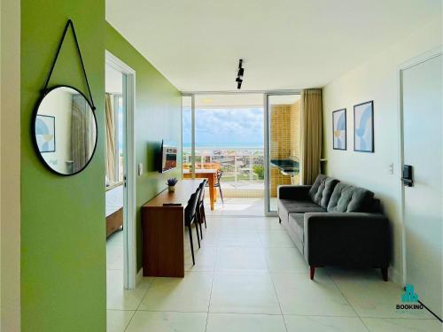 a living room with a couch and a mirror at Aquarius Style by Holiday Stays in Fortaleza