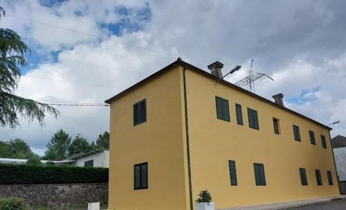 a yellow building with a roof on top of it at FOGAR CAÑÓN DO SIL - En la Ribeira Sacra in Nogueira de Ramuin