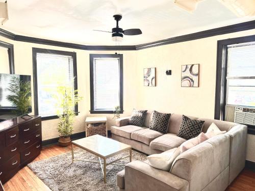 a living room with a couch and a table at Midway Hideaway -Cozy 1BR- parking in Chicago