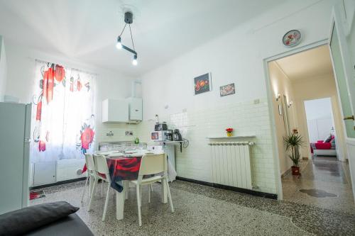 a kitchen with a table and chairs in a room at Casa Giorgia with Parking Space in Genova