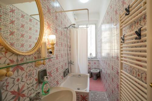 a bathroom with a sink and a mirror at Casa Giorgia with Parking Space in Genova