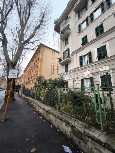 a building with a fence in front of a street at Casa Giorgia with Parking Space in Genova