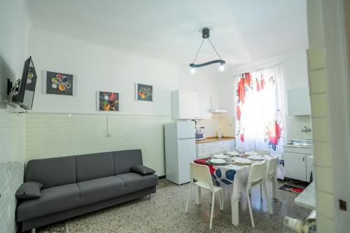 a living room with a couch and a table at Casa Giorgia with Parking Space in Genova