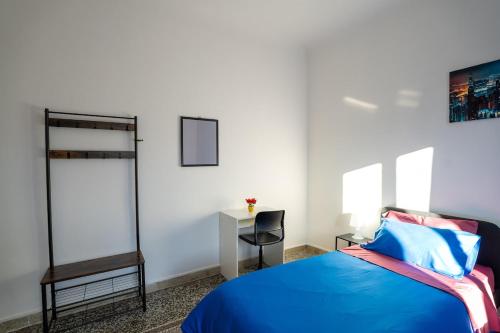 a bedroom with a blue bed and a desk at Casa Giorgia with Parking Space in Genova