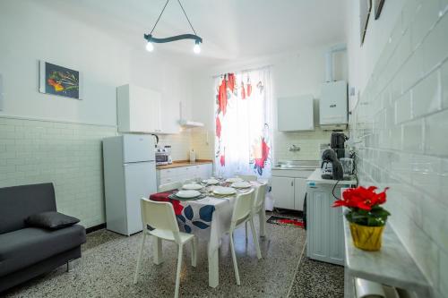 a kitchen with a table and chairs in a room at Casa Giorgia with Parking Space in Genova
