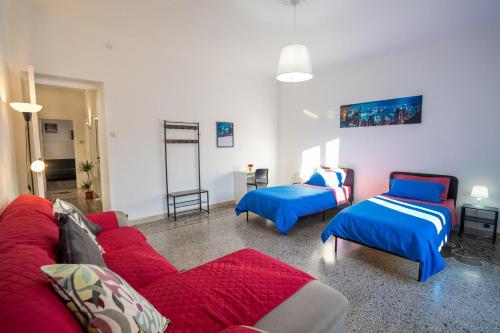 a living room with a couch and two beds at Casa Giorgia with Parking Space in Genova