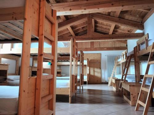 a room with several bunk beds in a house at Malga Pontara in Bedollo