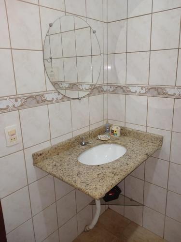 a bathroom with a sink and a mirror at Flor da Serra Chalés in Nova Friburgo