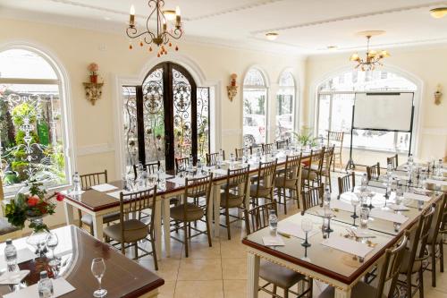 a row of tables in a room with windows at Eugenia Hotel in Quito