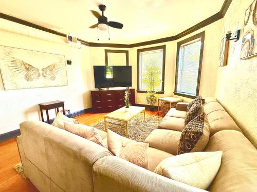 a living room with a couch and a flat screen tv at Midway Hideaway -Cozy 1BR- parking in Chicago