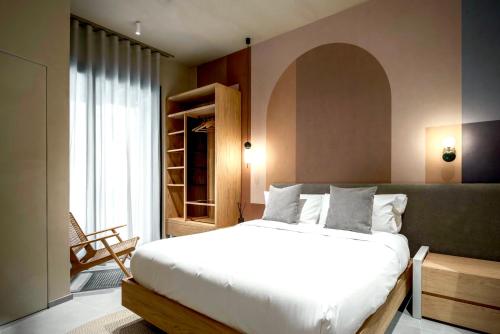 a bedroom with a large white bed and a window at Locanda Expanificio in Agrigento
