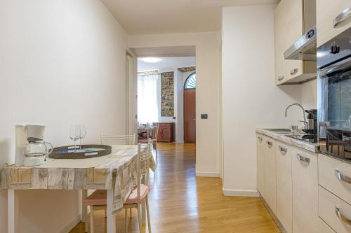 a kitchen with a table and a dining room at River House Lenno - Tremezzina - Como Lake in Lenno