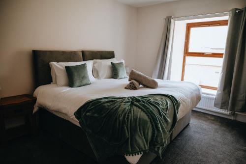 a bedroom with a large bed with a window at Vale Farm Cottages in Brecon