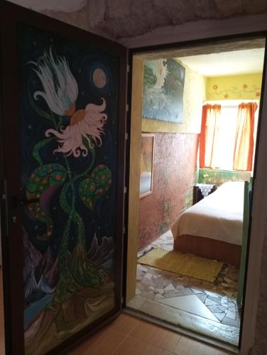 a mirror in a room with a painting on the door at Apartman SIRENA in Pićan