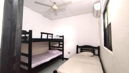 two bunk beds in a room with a ceiling at GiGi House 2 in Taganga