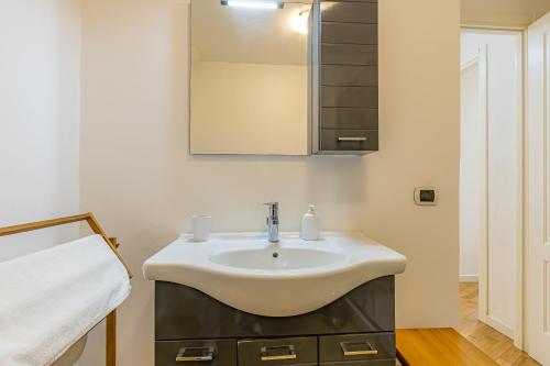 a bathroom with a sink and a mirror at River House Lenno - Tremezzina - Como Lake in Lenno
