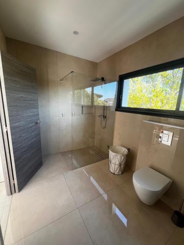 une salle de bain avec douche et toilettes et une fenêtre dans l'établissement Villa 200m2 -plages - piscine chauffée, à Fréjus