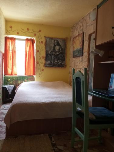a bedroom with a bed and a table and a window at Apartman SIRENA in Pićan
