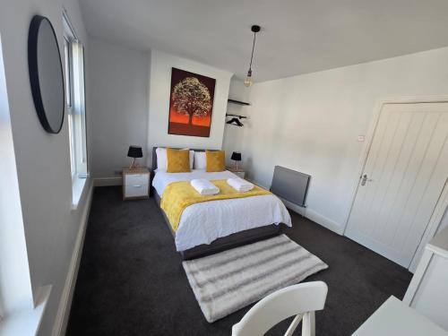 a bedroom with a king sized bed with yellow sheets at Room 3 Shared house in Kensington in Liverpool