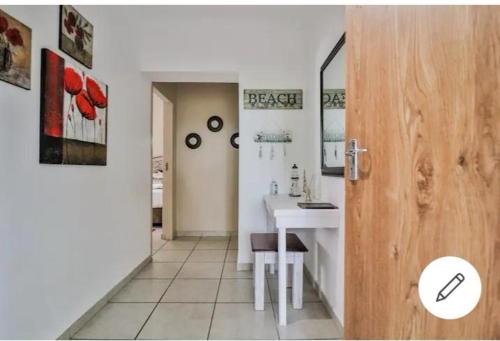a bathroom with a white sink and a desk at St Lucia Safari Lodge Holiday Home in St Lucia